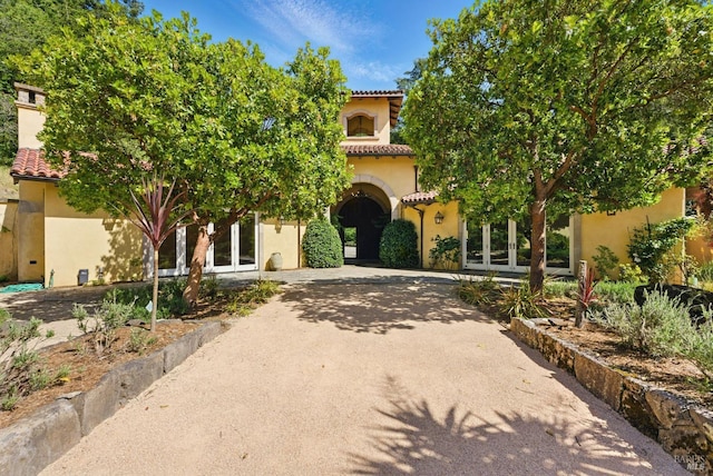 11018 Moonshine Rd, Sebastopol, CA 95472 - mediterranean / spanish-style house featuring french doors, stucco siding, a tiled roof, and curved driveway