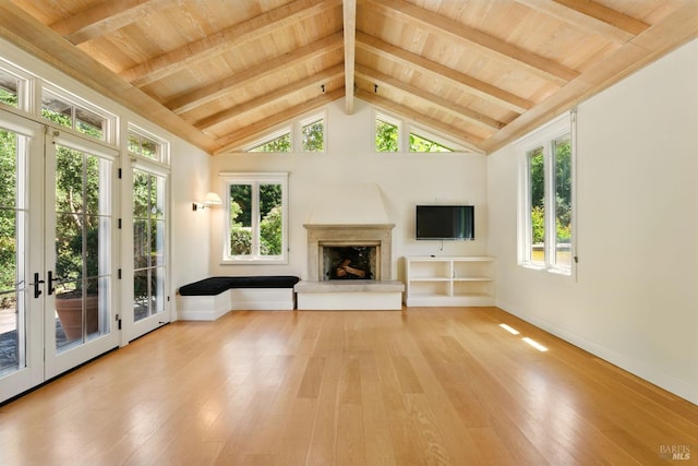 11018 Moonshine Rd, Sebastopol, CA 95472 - unfurnished living room with a wooden ceiling with exposed beams, a fireplace with raised hearth, light wood-style flooring, french doors, and high vaulted ceiling