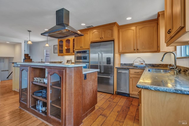 1130 W 9th St, Benicia, CA 94510 - kitchen featuring stainless steel appliances, island range hood, wood-type flooring, a kitchen island, and recessed lighting