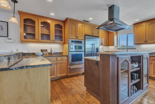 1130 W 9th St, Benicia, CA 94510 - kitchen featuring a warming drawer, island range hood, appliances with stainless steel finishes, light wood-type flooring, and recessed lighting