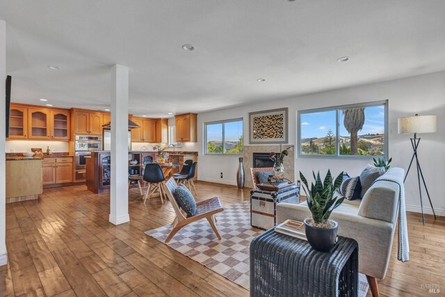 1130 W 9th St, Benicia, CA 94510 - living room featuring recessed lighting, light wood-type flooring, and a glass covered fireplace