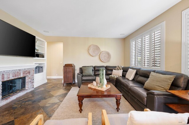 479 Jasper Ct, Benicia, CA 94510 - living room with built in features, stone tile flooring, and a brick fireplace