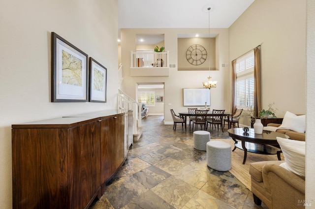 479 Jasper Ct, Benicia, CA 94510 - living room with a towering ceiling, healthy amount of natural light, stone tile floors, and a chandelier