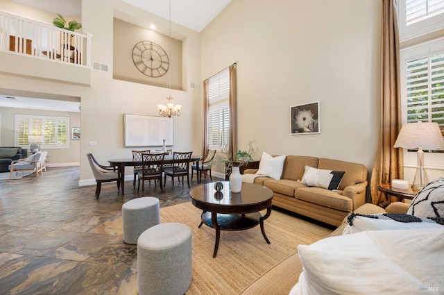 479 Jasper Ct, Benicia, CA 94510 - living room with a high ceiling, stone tile floors, and a chandelier