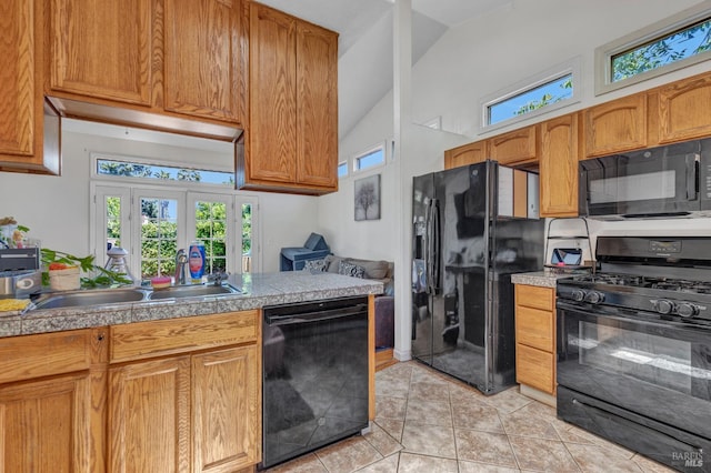 2720 Laurel St, Napa, CA 94558 - kitchen featuring black appliances, light tile patterned floors, plenty of natural light, high vaulted ceiling, and brown cabinets