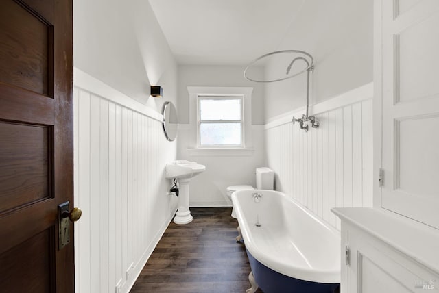 1763 2nd St, Napa, CA 94559 - bathroom featuring a freestanding bath, wood finished floors, and wainscoting