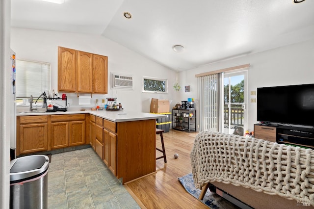 2290 Woolsey Rd, Fulton, CA 95439 - kitchen with lofted ceiling, a wall mounted AC, a peninsula, light countertops, and a kitchen bar