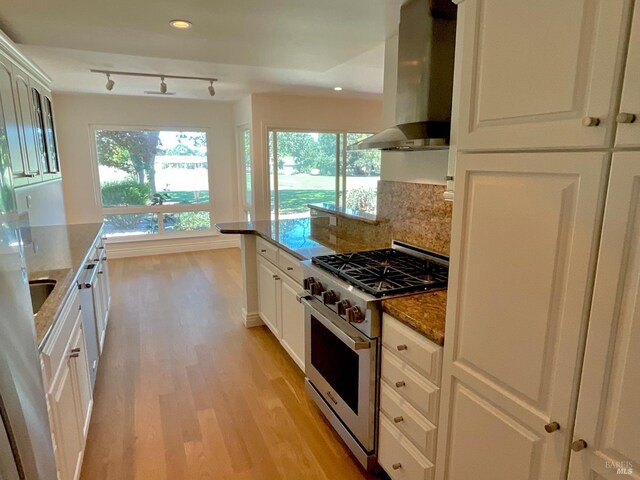 164 Oak Island Dr, Santa Rosa, CA 95409 - kitchen featuring high end range, island exhaust hood, light wood finished floors, white cabinets, and dark stone countertops