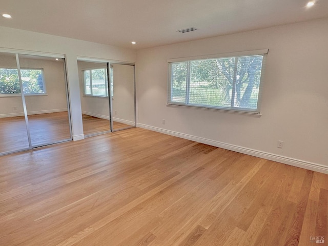 164 Oak Island Dr, Santa Rosa, CA 95409 - unfurnished bedroom featuring two closets, light wood-type flooring, and recessed lighting