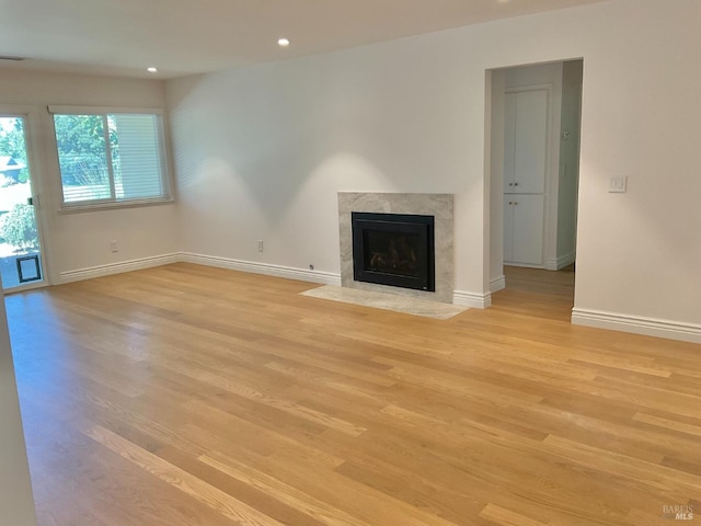 164 Oak Island Dr, Santa Rosa, CA 95409 - unfurnished living room featuring light wood finished floors, a premium fireplace, and recessed lighting