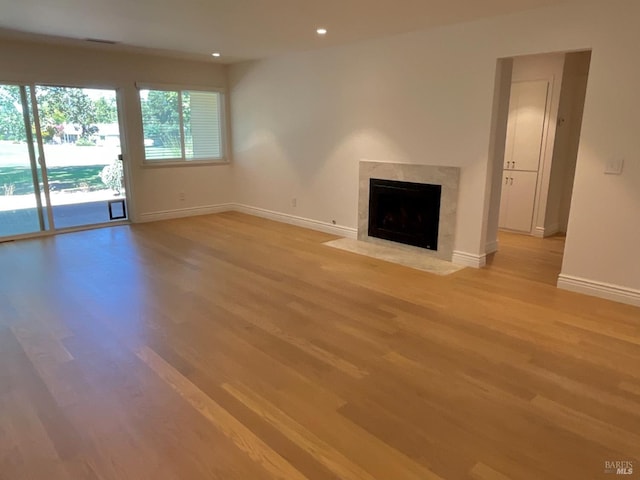 164 Oak Island Dr, Santa Rosa, CA 95409 - unfurnished living room with light wood finished floors, a high end fireplace, and recessed lighting