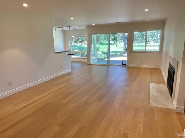 164 Oak Island Dr, Santa Rosa, CA 95409 - unfurnished living room featuring light wood-style flooring, recessed lighting, and a fireplace with flush hearth