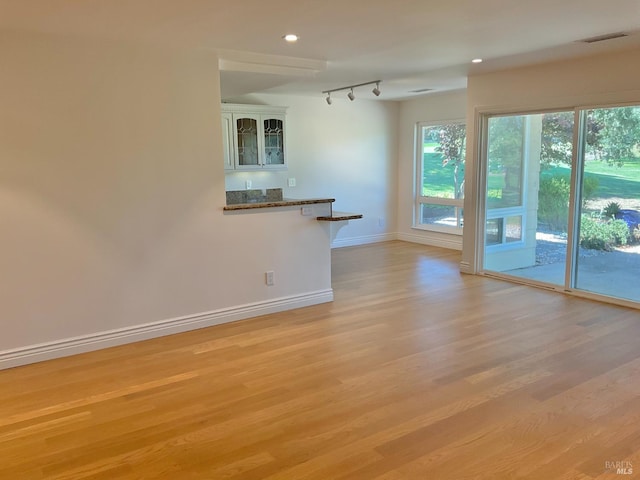 164 Oak Island Dr, Santa Rosa, CA 95409 - unfurnished living room with light wood-style flooring, track lighting, recessed lighting, and bar area