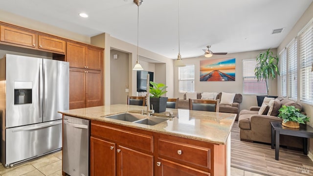 524 Chaparral Loop, Vacaville, CA 95688 - kitchen featuring stainless steel appliances, a center island with sink, open floor plan, brown cabinetry, and recessed lighting