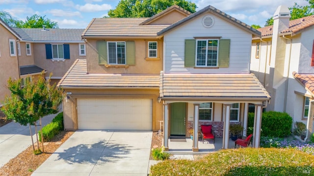 524 Chaparral Loop, Vacaville, CA 95688 - view of front of home featuring covered porch, a garage, concrete driveway, a tiled roof, and stucco siding