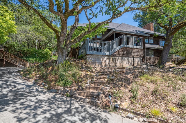 3604 Holly Ridge Dr, Santa Rosa, CA 95409 - view of front facade with stairway, a chimney, a shingled roof, and a deck