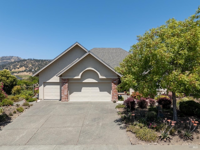 6327 Meadowridge Dr, Santa Rosa, CA 95409 - view of front of home with an attached garage, driveway, stucco siding, and brick siding