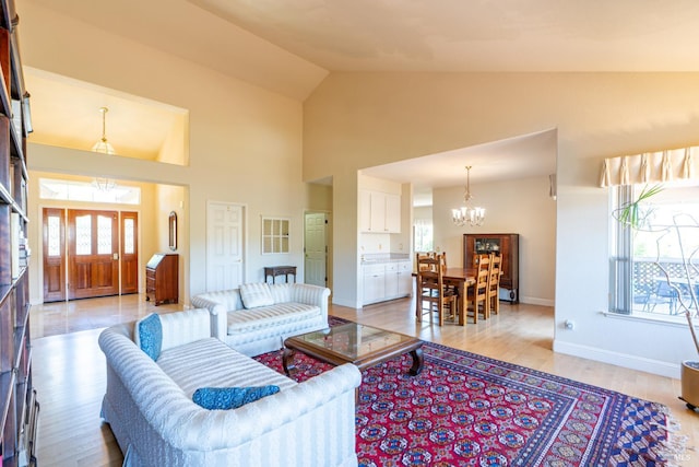6327 Meadowridge Dr, Santa Rosa, CA 95409 - living room with a chandelier, light wood-style flooring, and high vaulted ceiling
