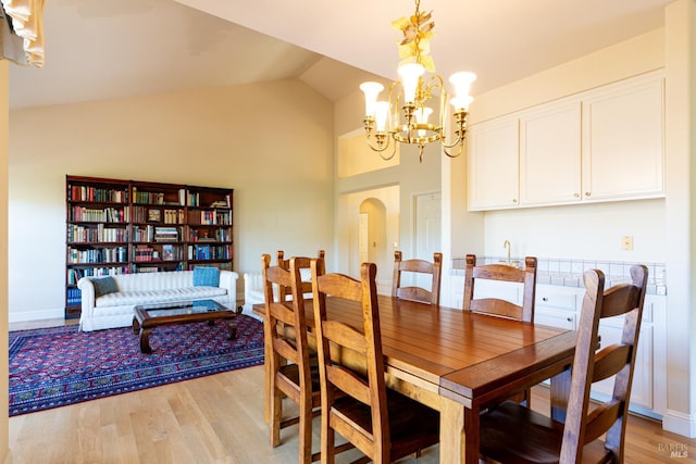 6327 Meadowridge Dr, Santa Rosa, CA 95409 - dining room featuring a chandelier, light wood finished floors, arched walkways, and high vaulted ceiling