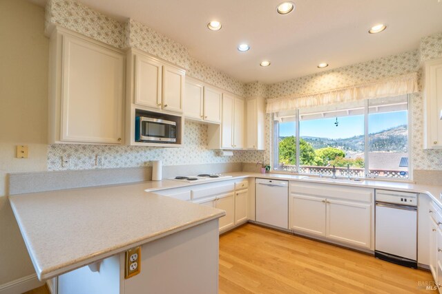 6327 Meadowridge Dr, Santa Rosa, CA 95409 - kitchen with white appliances, a peninsula, recessed lighting, light countertops, and light wood-style flooring