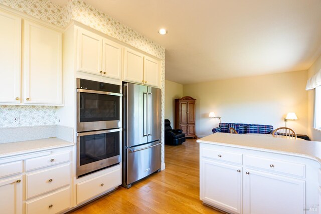 6327 Meadowridge Dr, Santa Rosa, CA 95409 - kitchen with stainless steel appliances, light countertops, light wood-type flooring, white cabinets, and recessed lighting