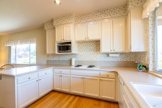 6327 Meadowridge Dr, Santa Rosa, CA 95409 - kitchen featuring white appliances, a peninsula, light countertops, light wood finished floors, and recessed lighting