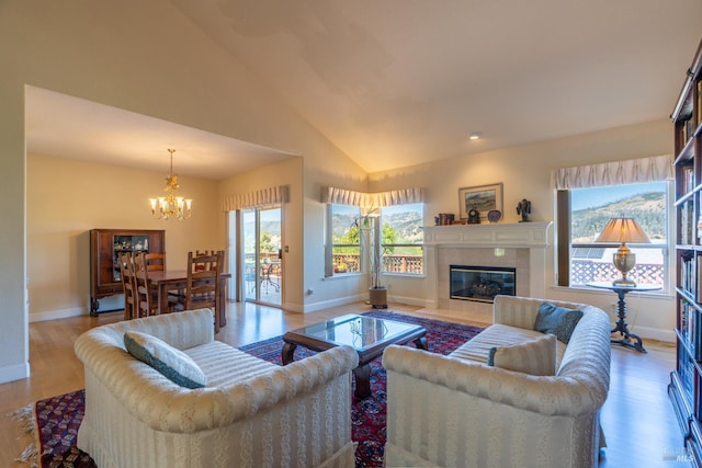 6327 Meadowridge Dr, Santa Rosa, CA 95409 - living room with a chandelier, vaulted ceiling, wood finished floors, and a tile fireplace