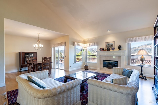 6327 Meadowridge Dr, Santa Rosa, CA 95409 - living room featuring a chandelier, light wood-style floors, vaulted ceiling, and a fireplace