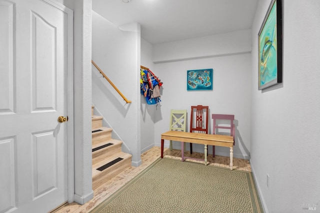 mudroom with wood finished floors and baseboards