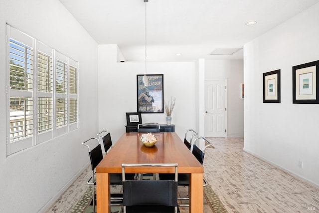 dining room featuring baseboards and recessed lighting