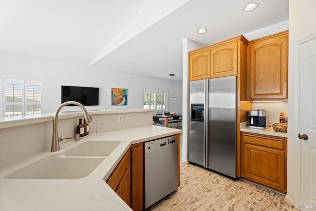 kitchen featuring appliances with stainless steel finishes, light countertops, recessed lighting, and brown cabinetry