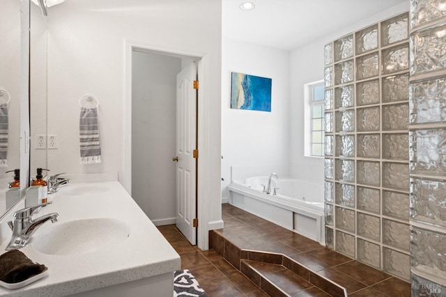 bathroom featuring a garden tub, double vanity, tile patterned flooring, and recessed lighting
