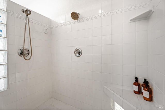 bathroom with a tile shower