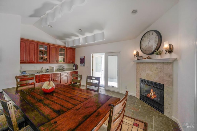 204 Foss Creek Cir Unit B, Healdsburg, CA 95448 - dining room with vaulted ceiling, dark stone finish flooring, and a fireplace