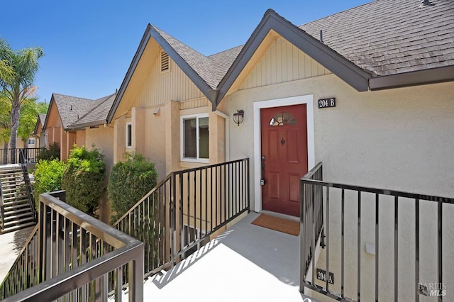 204 Foss Creek Cir Unit B, Healdsburg, CA 95448 - view of exterior entry with roof with shingles and stucco siding