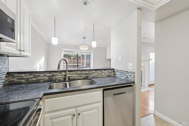 1255 Oak Ridge Ln, Pinole, CA 94564 - kitchen featuring appliances with stainless steel finishes, crown molding, decorative backsplash, white cabinets, and hanging light fixtures