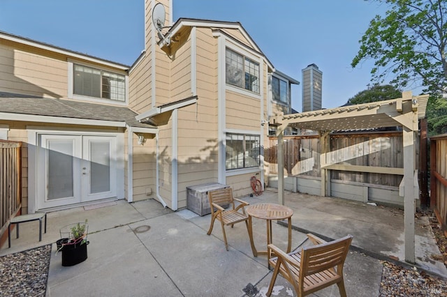 1255 Oak Ridge Ln, Pinole, CA 94564 - back of property with french doors, a patio, a chimney, and a fenced backyard