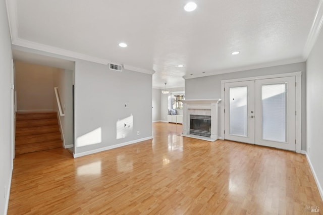 1255 Oak Ridge Ln, Pinole, CA 94564 - unfurnished living room featuring ornamental molding, recessed lighting, light wood finished floors, stairway, and french doors
