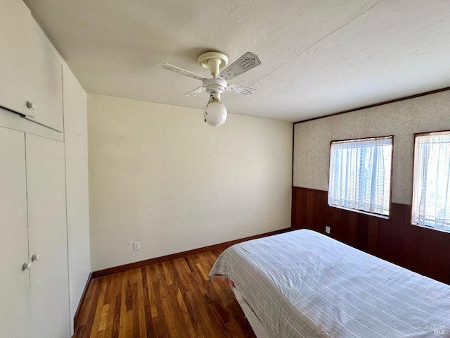 716 Mountain View Ave, Petaluma, CA 94952 - bedroom with wood finished floors, wainscoting, a ceiling fan, and wood walls