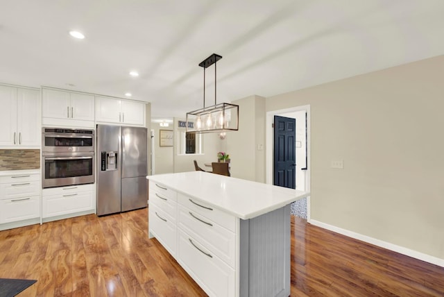 2588 King Edward Ct, El Dorado Hills, CA 95762 - kitchen with stainless steel appliances, light countertops, light wood-style floors, white cabinets, and recessed lighting
