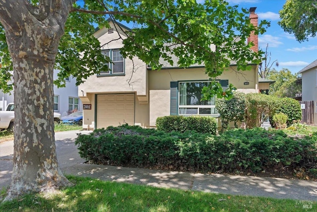 2014 Indiana St, Vallejo, CA 94590 - view of front of home featuring stucco siding, an attached garage, and a chimney