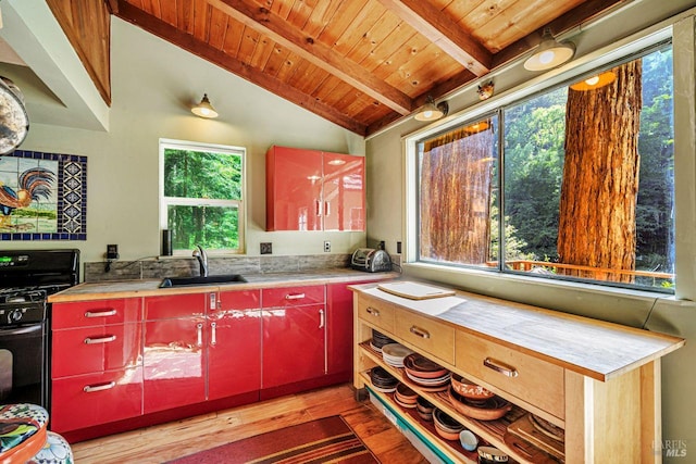 2685 Austin Creek Rd, Cazadero, CA 95421 - kitchen featuring red cabinets, gas stove, light wood-style flooring, wood ceiling, and light countertops