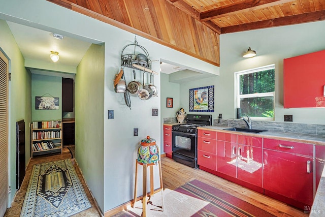 2685 Austin Creek Rd, Cazadero, CA 95421 - kitchen featuring black range with gas stovetop, red cabinets, a wood ceiling with exposed beams, light wood finished floors, and light countertops