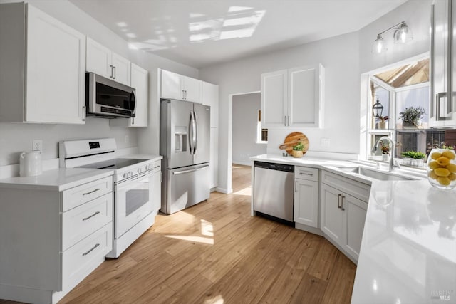 766 Calico Trl, Vacaville, CA 95687 - kitchen featuring appliances with stainless steel finishes, light wood finished floors, light countertops, and white cabinetry