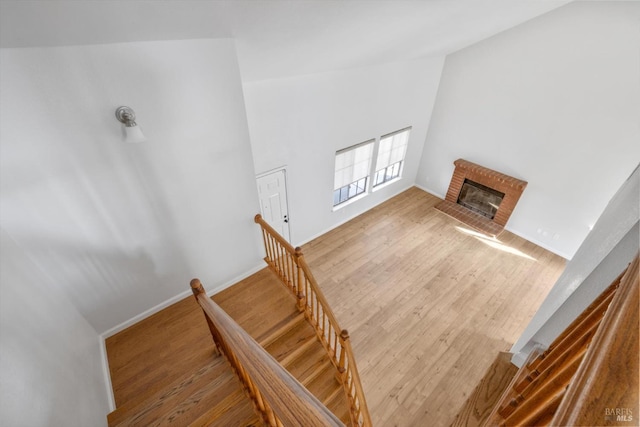 766 Calico Trl, Vacaville, CA 95687 - stairs with wood finished floors, a brick fireplace, and high vaulted ceiling