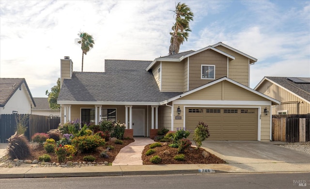 766 Calico Trl, Vacaville, CA 95687 - traditional-style house with driveway, a chimney, roof with shingles, covered porch, and an attached garage
