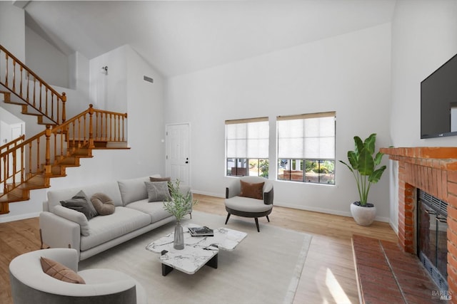 766 Calico Trl, Vacaville, CA 95687 - living room with high vaulted ceiling, wood finished floors, a fireplace, and stairway