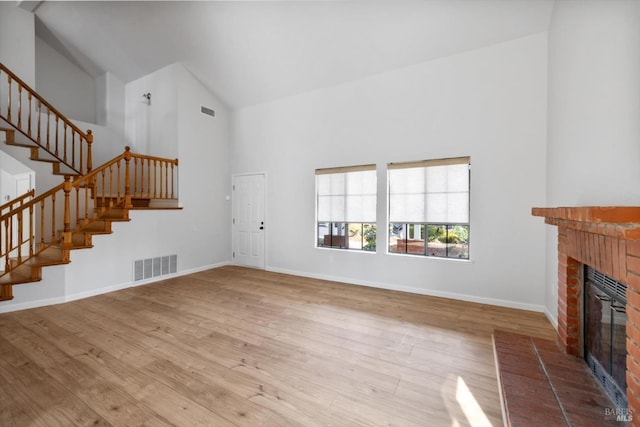 766 Calico Trl, Vacaville, CA 95687 - unfurnished living room with high vaulted ceiling, a fireplace, stairway, and wood finished floors