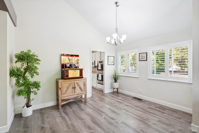 1105 Coulter Ct, Fairfield, CA 94533 - dining space featuring a chandelier, light wood-style flooring, and high vaulted ceiling
