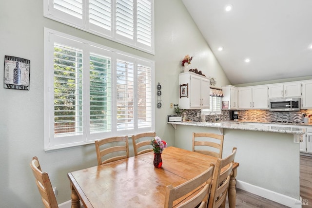 1105 Coulter Ct, Fairfield, CA 94533 - dining space with wood finished floors, high vaulted ceiling, and recessed lighting